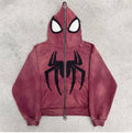 Faded Crimson full-face zip hoodie laid flat on concrete with the hood zipped shut into a mask