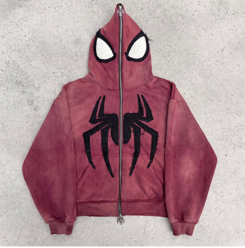 Faded Crimson full-face zip hoodie laid flat on concrete with the hood zipped shut into a mask