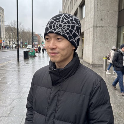 Black and ash web knit beanie worn with a casual streetwear outfit