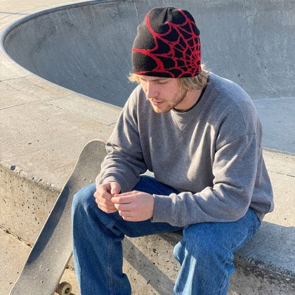 Black and crimson web knit beanie styled in an everyday setting